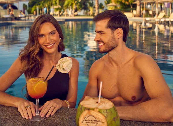 Casal brindando na piscina
